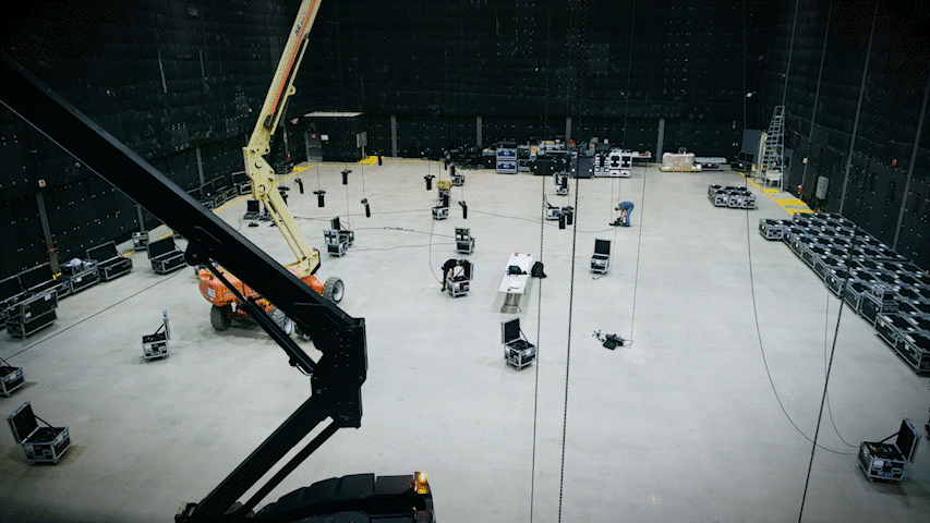 Event production crew setting up a large corporate event venue.