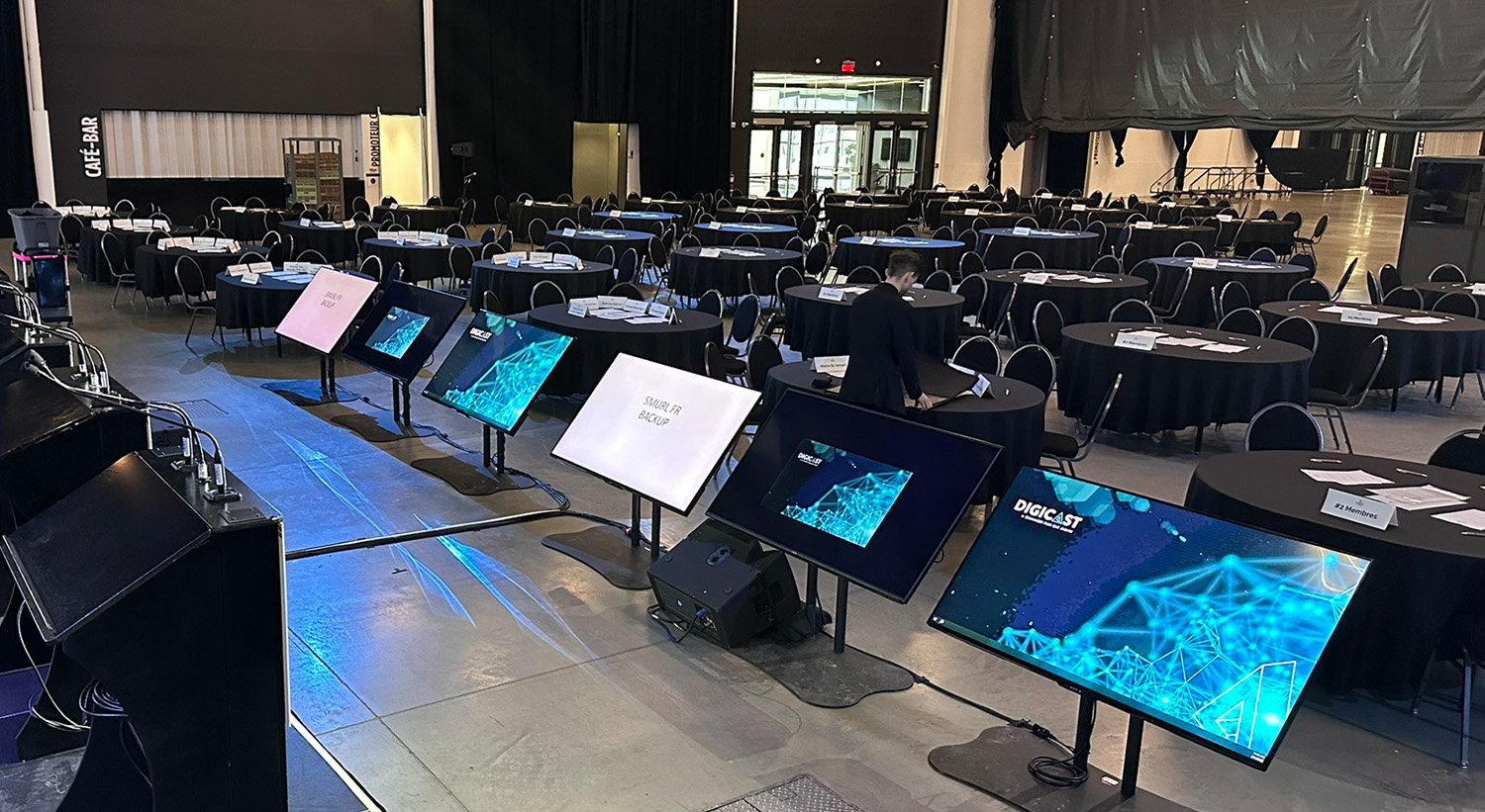 Technical production setup for a corporate event with presentation displays.