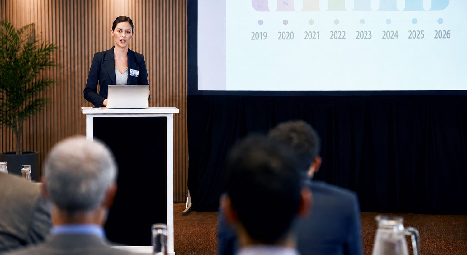 résentatrice animant une présentation corporative devant des employés lors d’une réunion interne.
