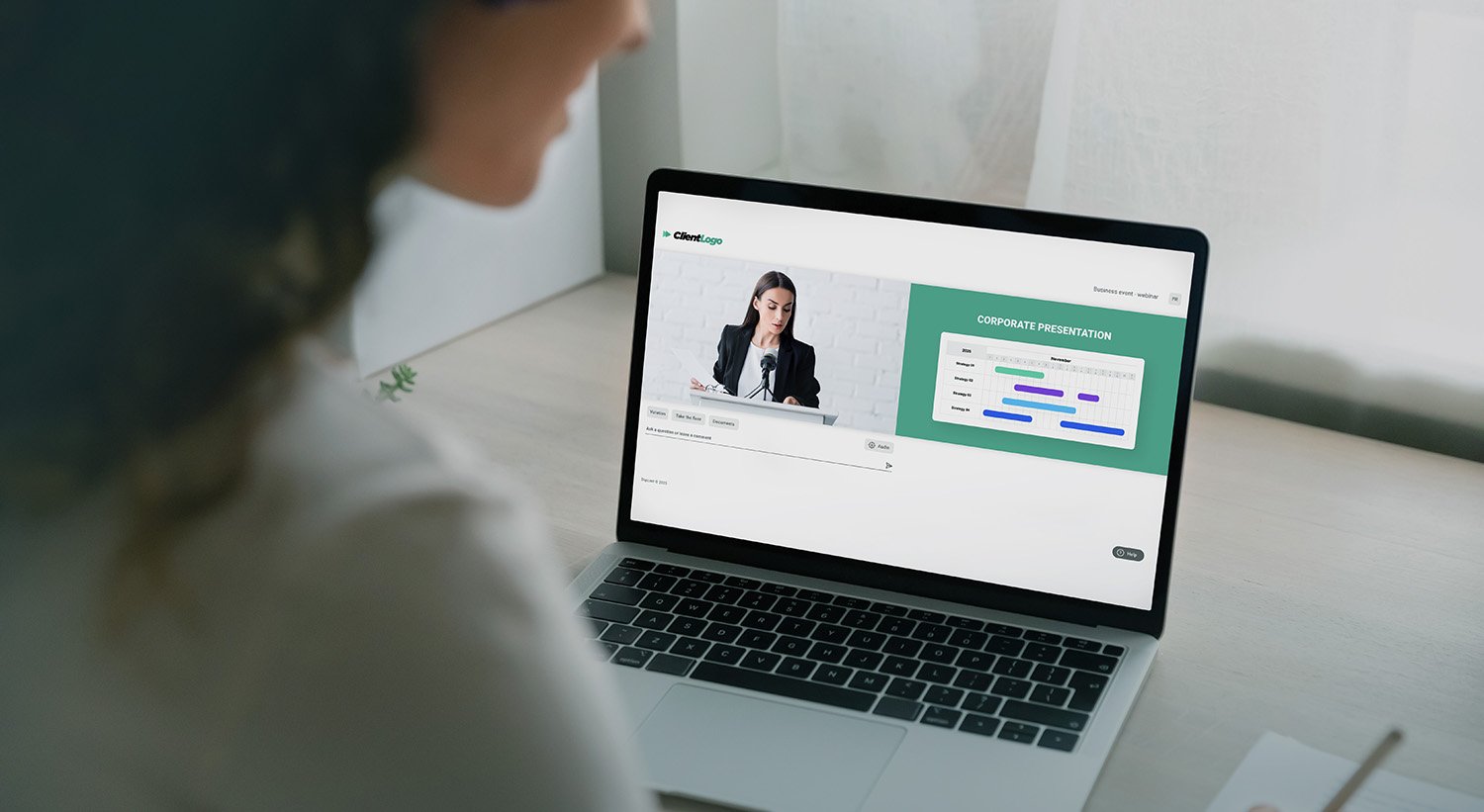 Employee viewing a corporate webcast and presentation from a laptop.