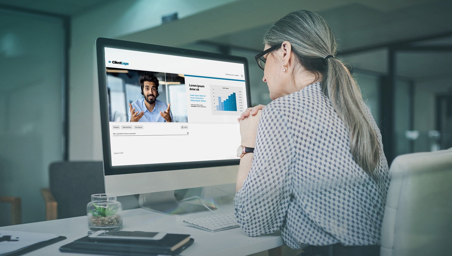 Professional participating in a virtual event from a desktop workstation.